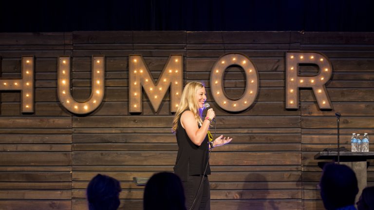 Alumna Kendall Ketchum performs her comedy routine at KAABOO’s comedy club in Del Mar, California. Submitted photo