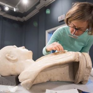 Conservator Amy Jones Abbe gives the Bust of an Unknown Roman a careful cleaning as part of her residency at University Museum. Photo by Kevin Bain/Ole Miss Communications