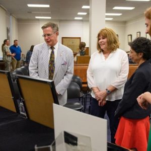 Chancellor Jeffrey Vitter (left) and his wife, Sharon, look over a recent addition to the Department of Archives and Special Collections with library Dean Cecilia Botero and Jennifer Ford, head of special collections.