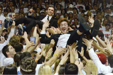 Blake Pruett and Patrick Haadsma, known as King Kobraz, crowd surf while shooting the video for their new song "TSUNs of Guns" before the basketball game against Kentucky. Photo by Phillip Waller for the Daily Mississippian