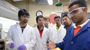 Dr. Dass (blue coat) and students. Photo by UM Communications
