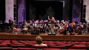 Nancy Van de Vate listens to the cast and orchestra during the sitzprobe, or seated rehearsal, in the Ford Center.
