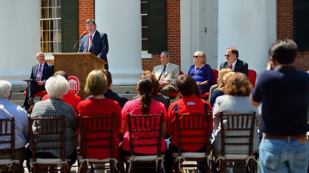  Morris Stocks (standing), acting chancellor at the University of Mississippi, announces that the Gertrude C. Ford Foundation has agreed to increase its support for the university’s new science building during a Friday (Sept. 4) event on the steps of the Lyceum. Also participating the announcement are Acting Provost Noel Wilkin (left) and Ford Foundation board members Anthony Papa, Cheryle Sims and John Lewis. Photo by Robert Jordan/Ole Miss Communications