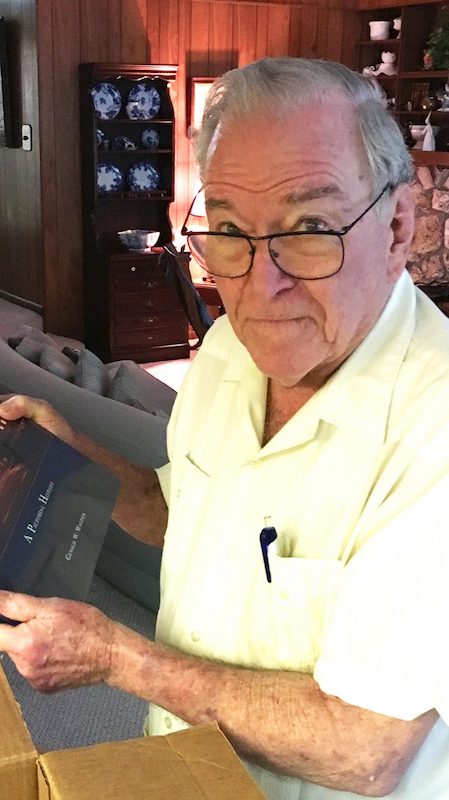 Dr. Creighton Wilson, at his home in Gainesville, Florida, opens a box of Ole Miss memorabilia sent to him from the UM Foundation in recognition of his many years of giving to the university.
