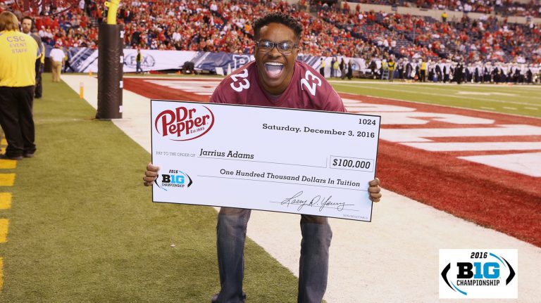 UM sophomore Jarrius Adams holds the $100,000 check he won during the Dr. Pepper Tuition Giveaway football throw-off in Indiana. Submitted photo
