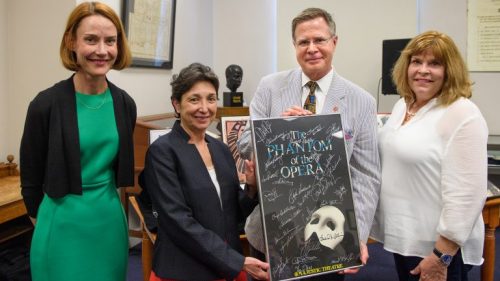Jennifer Ford (left), head of the Department of Archives and Special Collections, and Cecilia Botero, UM dean of libraries, share an autographed poster from ‘The Phantom of the Opera’ with Chancellor Jeffrey Vitter and his wife, Sharon. The poster is a gift from the Actors Fund of America. Photo by Robert Jordan/Ole Miss Communications