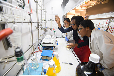 Dr. Davita Watkins (center) in her lab with students Duong Ngo and Briana Simms