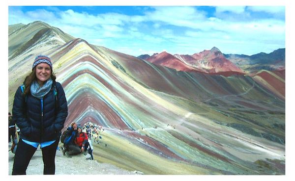 Abby Bruce stands at 17,060 feet in front of Montaña de Siete Colores in Cusco, Peru.