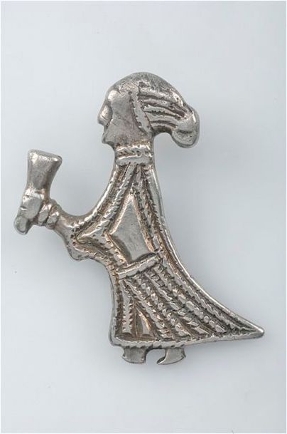 This small silver pendant, which is around an inch high, found in Sweden, is interpreted as a Valkyrie offering a cup of mead to welcome a fallen warrior to Valhalla, the hall of the slain, according to Norse mythology. Submitted photo by Creative Commons