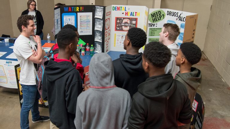Connor Ball (left), a senior pre-med biology student from Madison, talks with Quitman County High School students about the importance of hydration and healthy snacking. Photo by Michaela Cooper