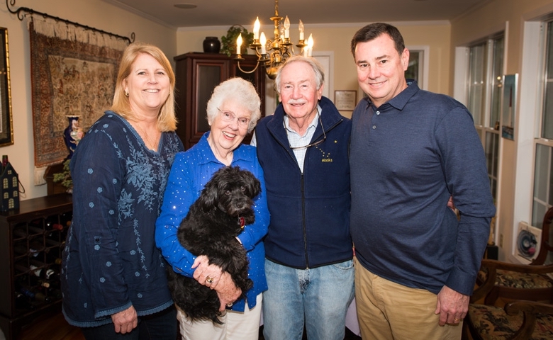 Lee Anne (left) and Bill Fry (right) visit with Sandy (holding Collette) and Vaughn Grisham in their Oxford, Mississippi, home.