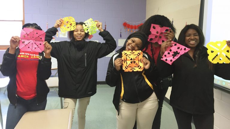 Victoria Nabors (left), T’khya Williams, Kelvisha Conner, Fredrekia Campbell and Kennytra Martin, all Chinese 1 students at Holly Spring High School, show off their Asian-themed paper cuttings at the school. UM photo by Linfei Yi