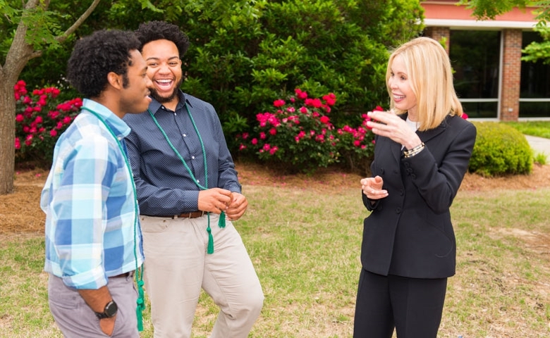 Renvy Pittman (right) chats with Grove Scholars Jontae Warren (left), a May graduate from Booneville, Mississippi, and Devante Yates, a senior from West Point, MS.