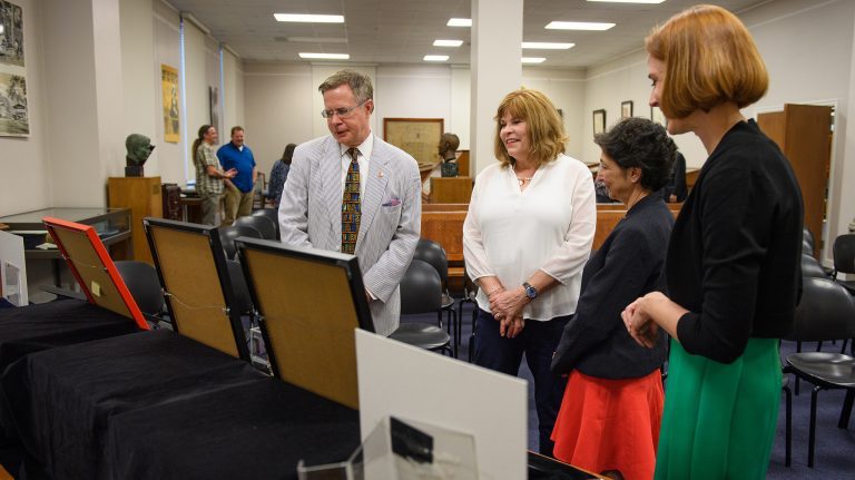 Chancellor Jeffrey Vitter (left) and his wife, Sharon, look over a recent addition to the Department of Archives and Special Collections with library Dean Cecilia Botero and Jennifer Ford, head of special collections.