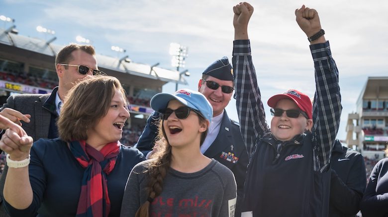 Ole Miss Wish Kid Benjamin Clark celebrates with his family when he hears that he is going to Disney World courtesy of the nonprofit Walkers for Warriors and the Student Veterans Association. Photo by Megan Wolfe