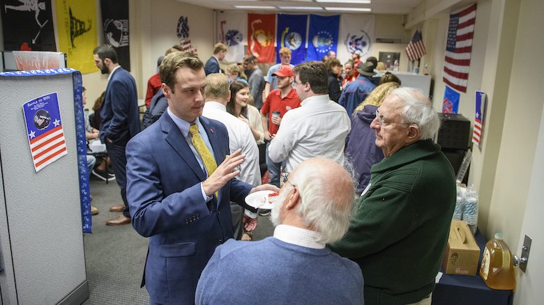 Andrew Newby (left), assistant director for Veteran and Military Services, speaks with guests at the opening of the Veterans Resource Center. Newby has implemented several new services that have helped Ole Miss rise in the rankings among public institutions for supporting military veteran students. Photo by Thomas Graning