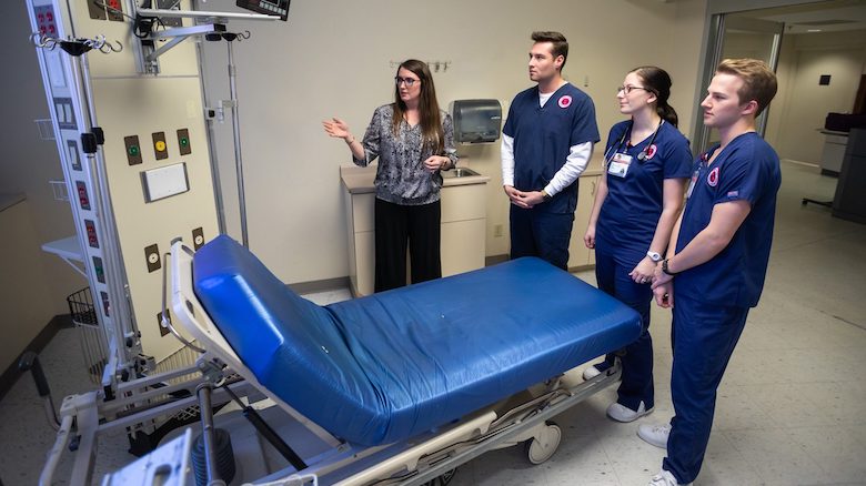 Eva Tatum (left), assistant professor in the UM School of Nursing, shows one of the future simulation labs in the former Intensive Care Unit of Baptist Memorial Hospital-North Mississippi to students Piercen Burchfield, Katelyn Hazelgrove and Charles Gill. 