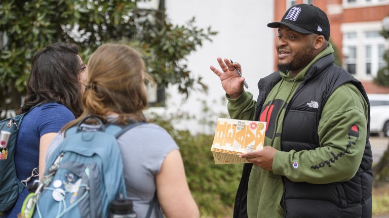 Kiese Laymon autographs a copy of his book ‘Heavy: An American Memoir’ for fans outside the Lafayette County Courthouse. Laymon was a featured speaker in the 2019 Conference for the Book. Photo by Thomas Graning