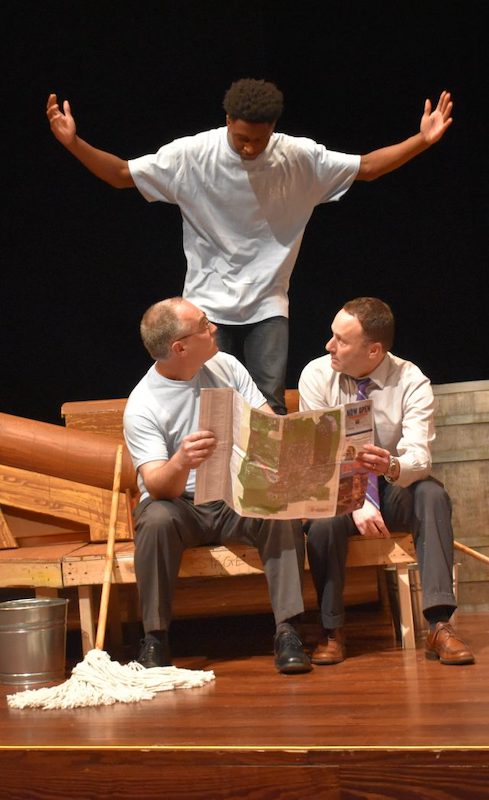 UM student Ontarius Woodland (top) catches Interim Chancellor Larry Sparks and Dean Lee Cohen sitting down on the job during a scene from the comic musical ‘H.M.S. Pinafore.’ 