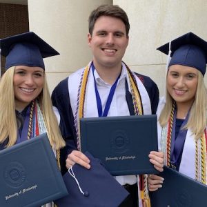 Katherine (left), Will and Ann Weston Sistrunk celebrate earning their degrees May 11 at the University of Mississippi’s Commencement ceremonies.