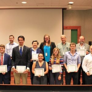 The 10 students involved with the inaugural Neuroscience Summer Research Education Program pose with their mentors during the program’s summer expo. Photo by Shea Stewart/University Marketing and Communications