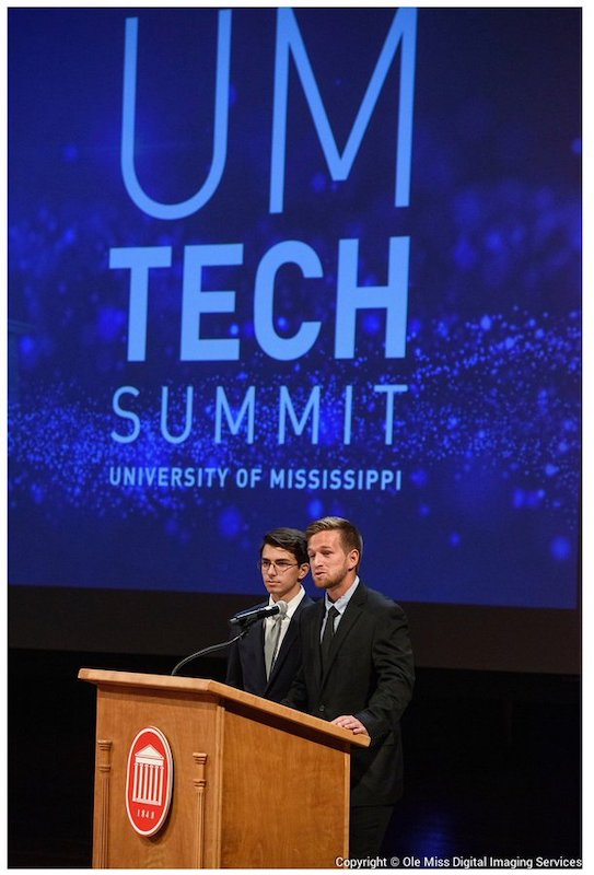 Gunner Rhoden, a biochemistry major (left), and Silvio Valladao, an exercise science graduate student, discuss Physiological Responses to Esports at the fourth Tech Summit. UM photo